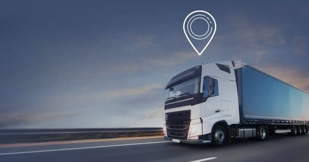 An articulated lorry on an open road at dusk