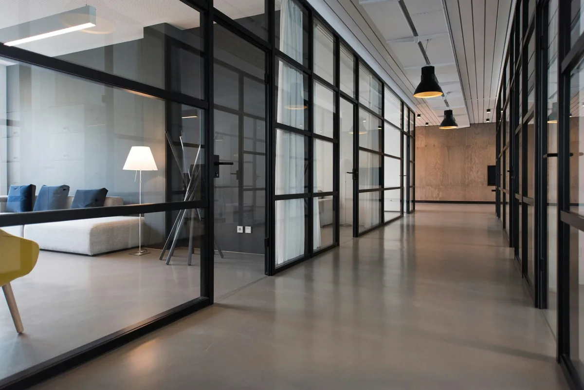 An open-plan office with glass meeting rooms